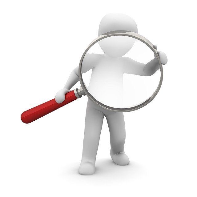 digital figure holding a huge magnifying glass