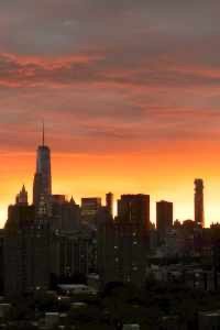 A Fiery Sunset behind a New York Skyline